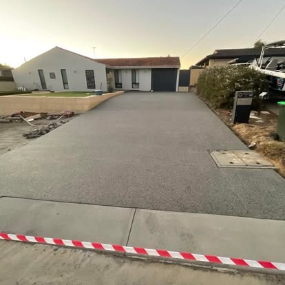 Concrete worker finishing a slab in WA